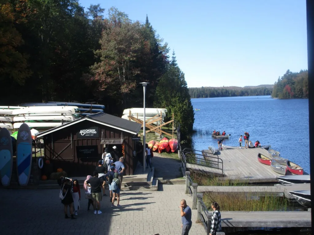 Line of people waiting to rent canoes at the Algonquin Provincial Park Portage Store with Canoe Lake