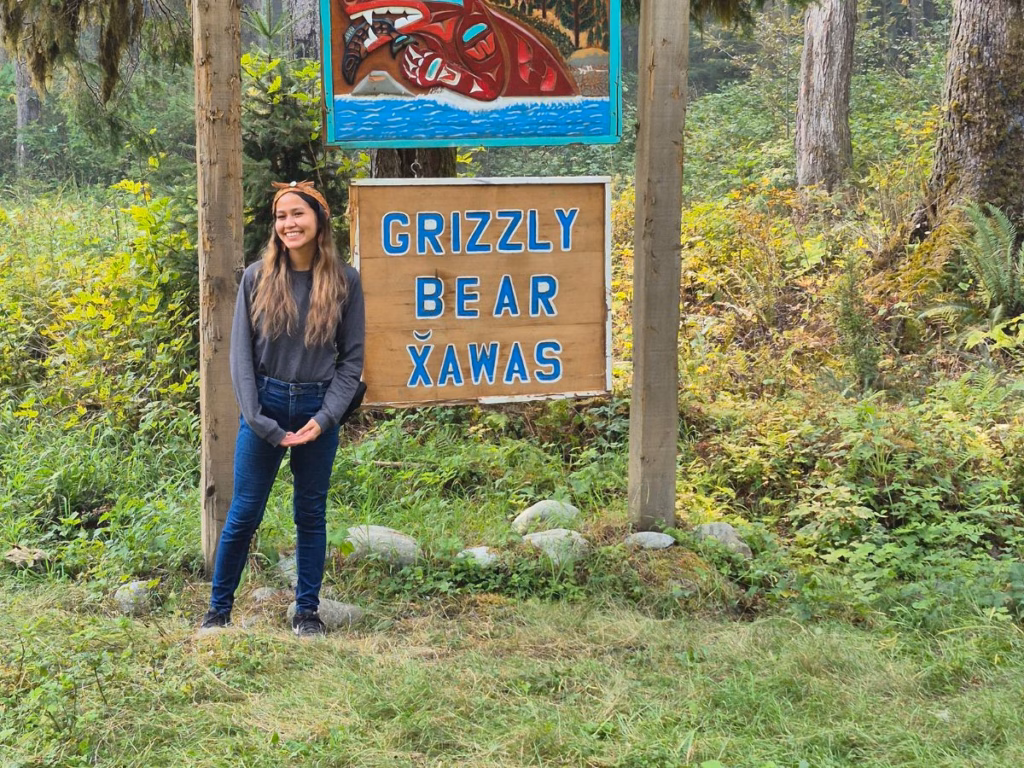 Tour Guide in front of sign during Grizzly Bear tour in BC